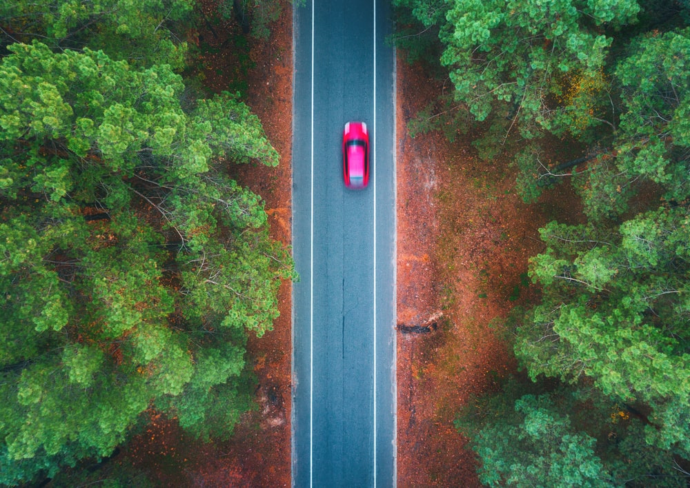 aerial-view-of-road-with-blurred-car-in-green-fore-2023-11-27-05-06-38-utc-min (1)